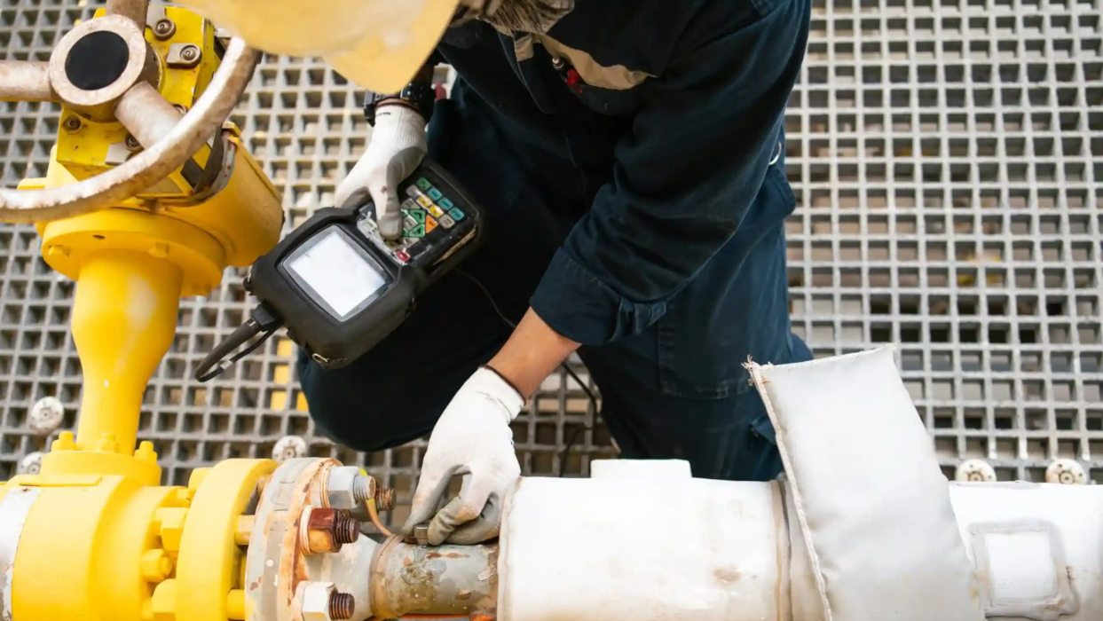 Worker inspecting equipment